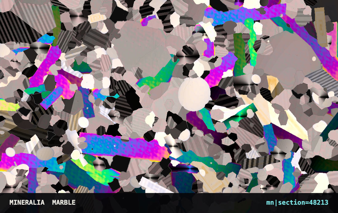 A card printed edge to edge with a slice of rock seen through a microscope: grey and white grains with bright magenta and green flakes among them, and a line of small numbers along the bottom